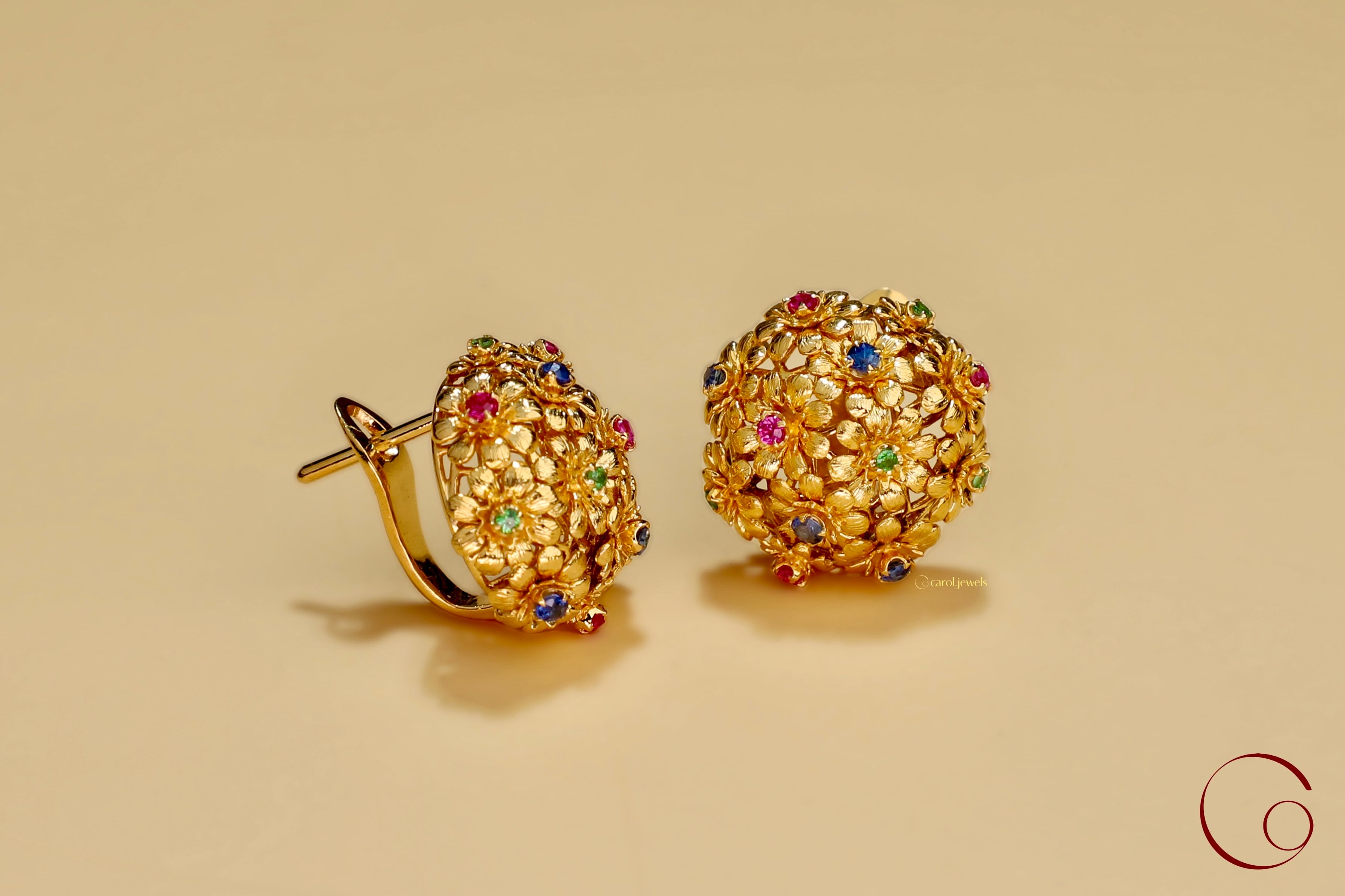 Small flowers with ruby, sapphires, tsavorites in the center, bundled together into a pair of fine jewelry earring